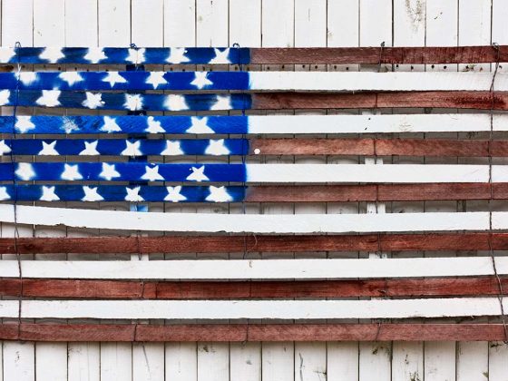 American flag on a White Fence