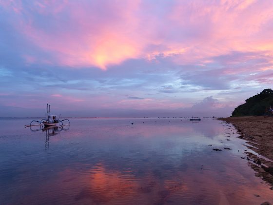Dramatic Sunset Scene with fishing boat (Jukung) in Bali